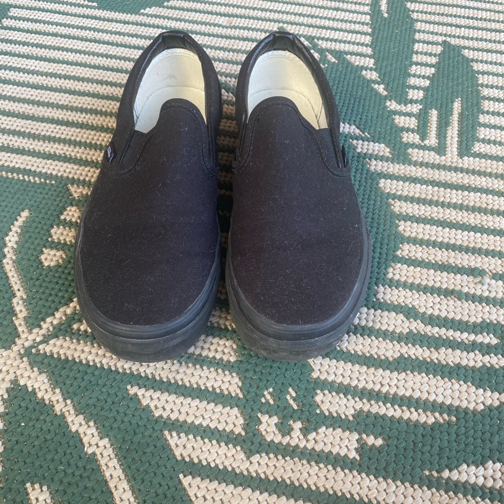 Vans all black slip-ons